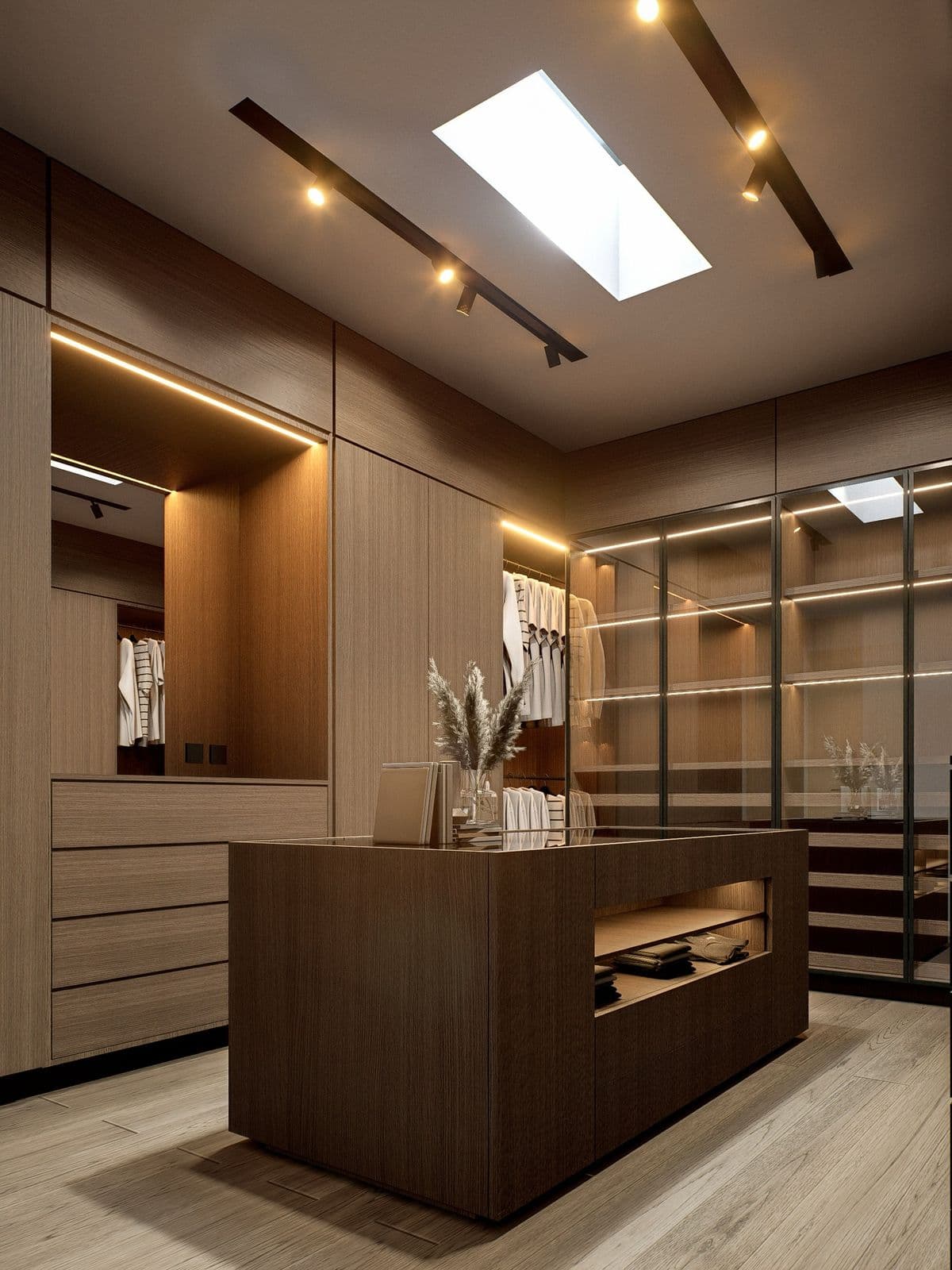 Vestidor con isla central, puertas de cristal e iluminación integrada